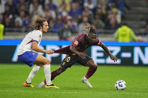 2024–25 UEFA Nations League, France vs Belgium:  France's Matteo Guendouzi, left, tries to stop Belgium's Jeremy Doku 